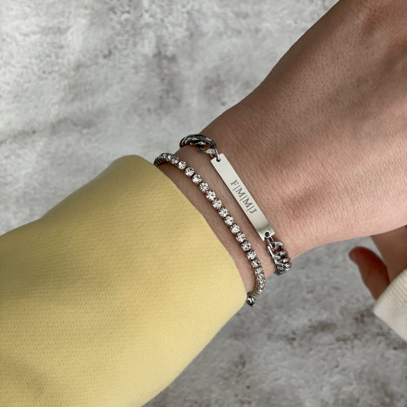 Mooie trendy schakelarmband in het zilver om de pols van het model